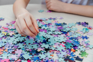 caucasian girl collects puzzles on the table 2022 02 18 15 31 17 utc